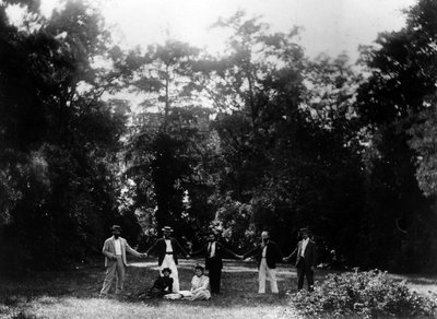 Group of friends holding hands in the garden of Le Relais, home of the Natanson family in Villeneuve-sur-Yonne, c. 1899 by French Photographer